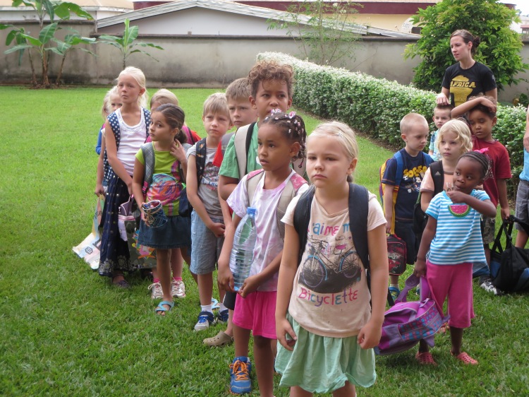 Kindergarten students (on right) and grade 1 & 2 students line up for class.